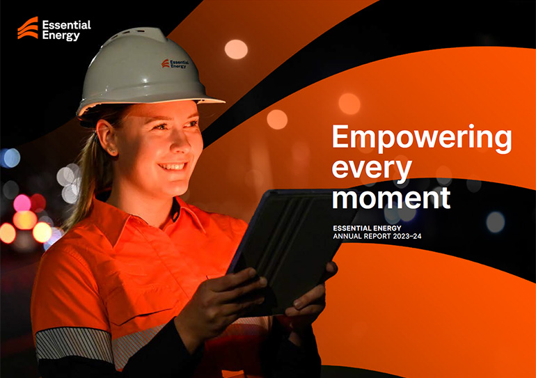 Worker smiling wearing a safety helmet and holding a tablet