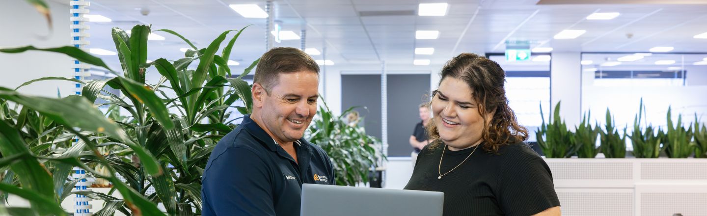 Two people looking at a laptop