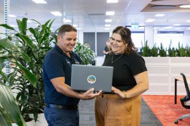 Two people looking at a laptop