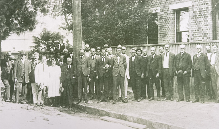 People standing near power pole