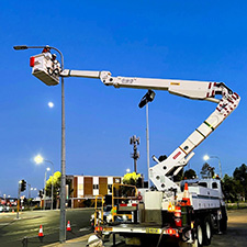 Crew installing a streetlight sensor