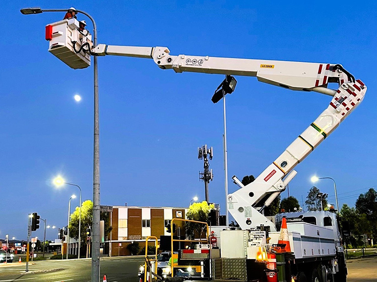 Crew installing a streetlight sensor