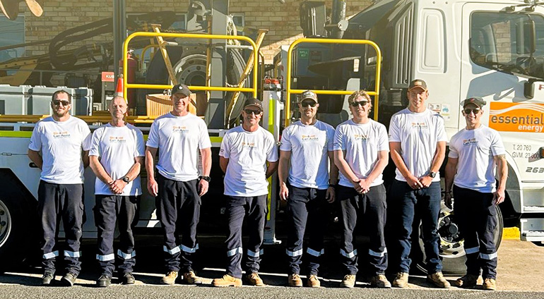 Armidale team standing in front of a truck