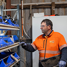 Worker standing near shelves