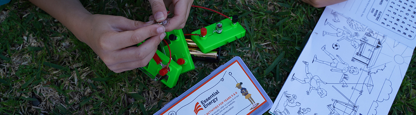 Hands working on an electricity education kit