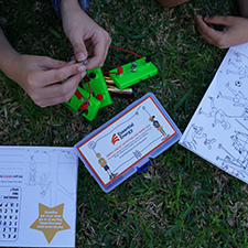Hands working on an electricity education kit