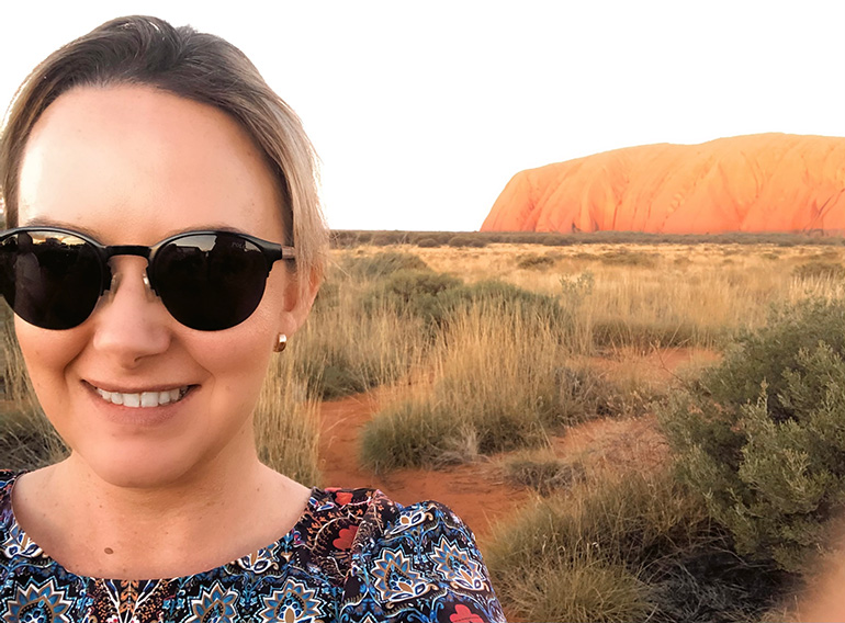 Hannah with Uluru in background