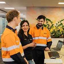 Three people talking in an office