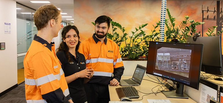 Three people talking in an office
