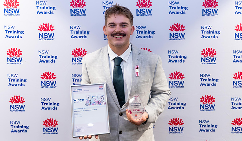 Jack holding his award and trophy
