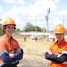 Two apprentices with arms folded