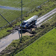 Broken pole with truck and worker nearby