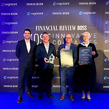 Four people smiling holding awards