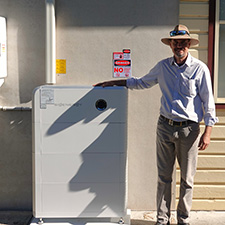 Man standing next to a battery