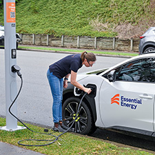 Lady charging an electric vehicle