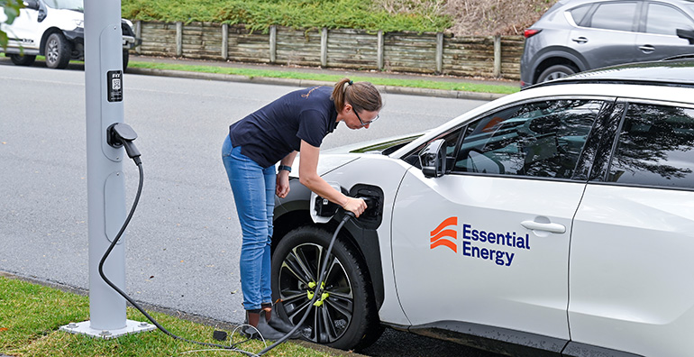 Lady charging an electric vehicle