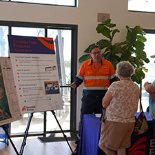 Worker explaining plans on a chart to two people