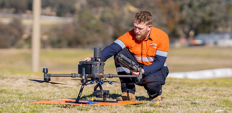 Worker with a drone on the ground