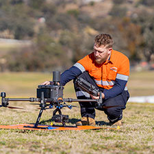 Worker with a drone on the ground