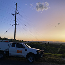 Car with powerlines and sunset