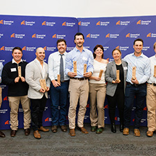 Graduates standing with their awards