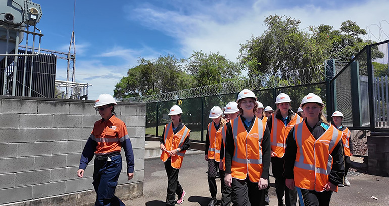 Students and employee walking through depot