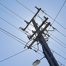 Power pole with sun in background