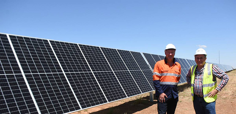 Standing in front of solar panels