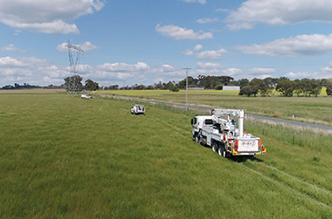 EWP and powerlines in a field
