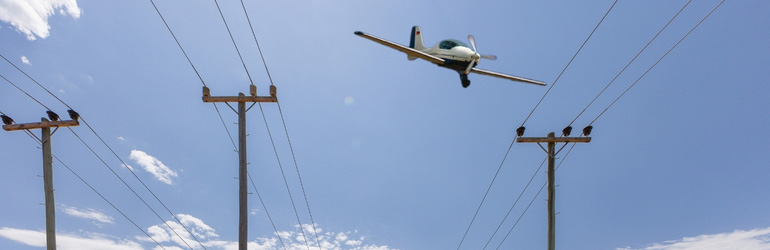 Plane flying near powerlines
