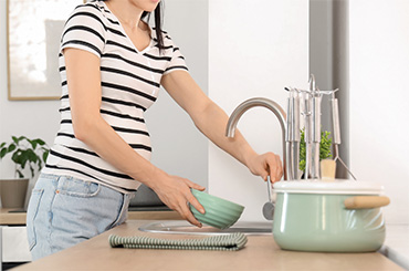 Girl washing hands in a sink
